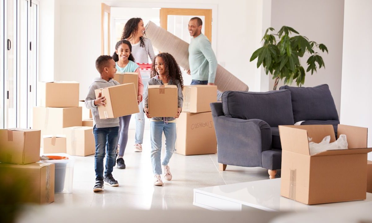 The Ultimate Relocation Guide Picture of Family Moving Boxes Into Their New Home